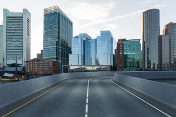 Fototapeta na wymiar Empty urban asphalt road exterior with city buildings background. New modern highway concrete construction. Concept of way to success. Transportation logistic industry fast delivery. Boston. USA.