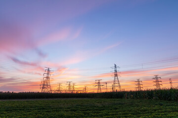Fototapeta premium In the evening, the silhouette of high voltage towers