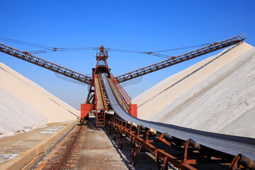 Fototapeta na wymiar Salt production.  machinery for the treatment of the salt, The equipment and salt stock of a salt plant