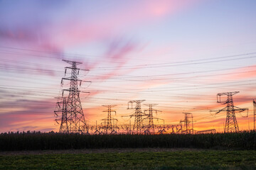 In the evening, the silhouette of high voltage towers