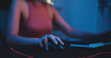 Pretty teenage professional gamer with gaming equipment to cast gameplay