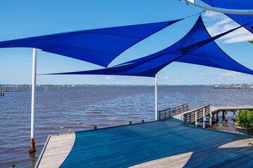 Fototapeta na wymiar Stuart Riverwalk scene with blue tarp cover