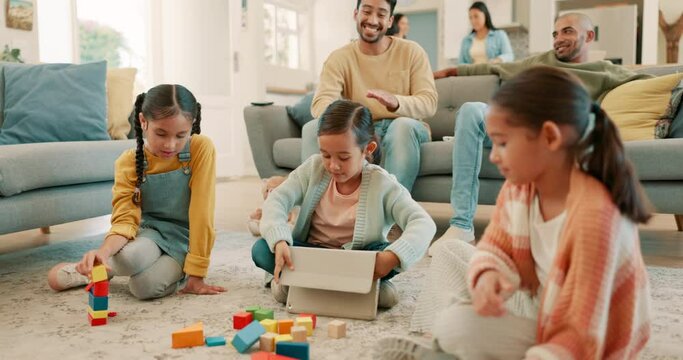 Family, home and children play with toys for bonding, quality time and child development. Parents, siblings and happy kids learning with tablet, building blocks and relax in living room on playdate