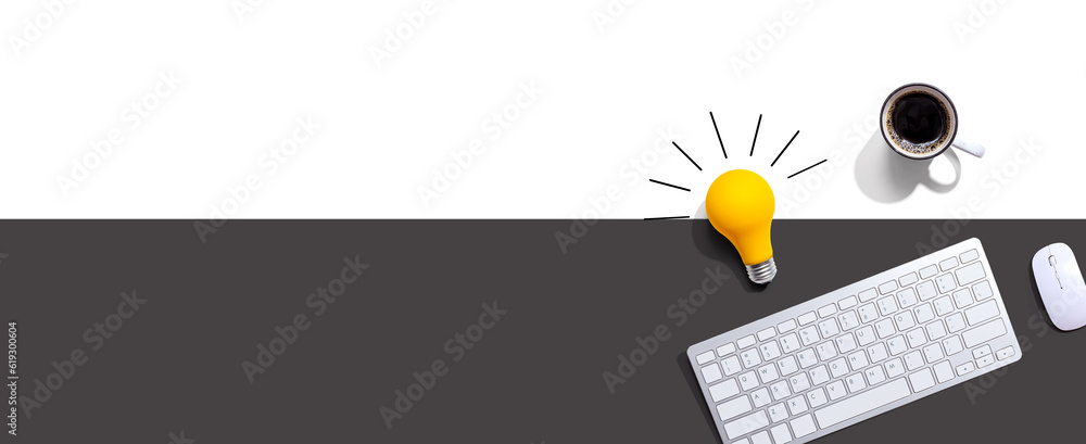 Poster computer keyboard with a yellow light bulb from above