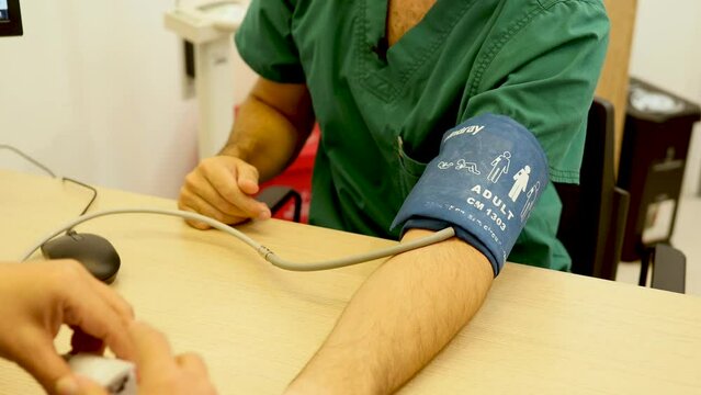 Nurse takes patient's blood pressure