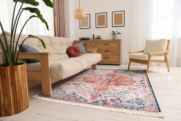 Beautiful rug, sofa, armchair and chest of drawers indoors