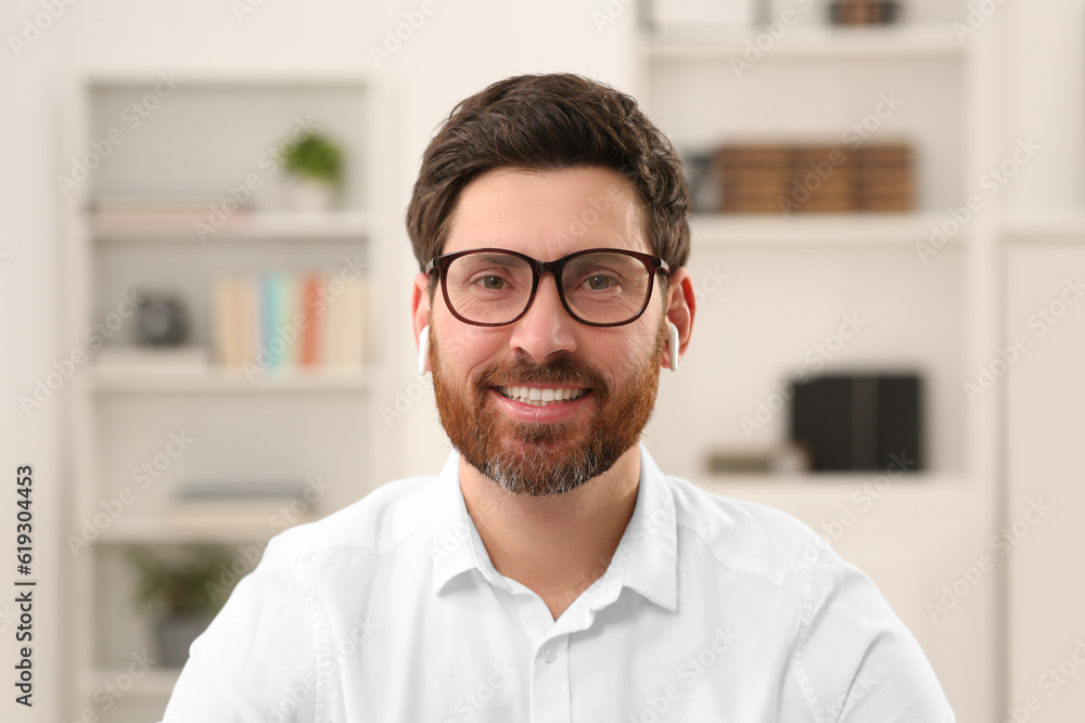 Wall mural happy businessman having online video call indoors, view from web camera