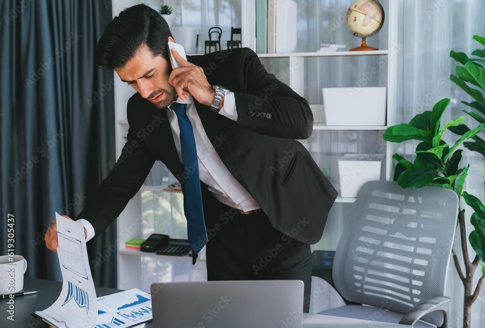 Poster diligent businessman busy talking on the phone call with clients while working with laptop in his of