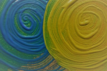 Blue and green swirl drawn with acrylic paint. Abstract background.