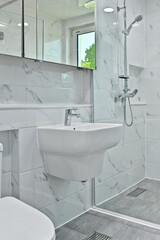 Stylish modern interior bathroom vanity with Bianco tiles