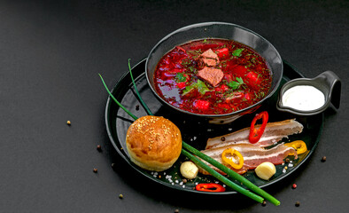 Ukrainian traditional borsch on blak table background. Borscht, borshch with beet