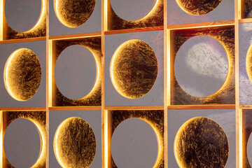 Decorative golden round tiles on the wall, close-up