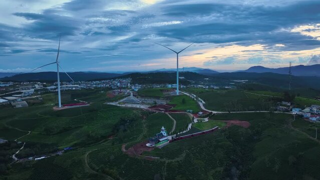 Drone view wind turbine in sunset on Cau Dat tea hill of Da Lat, Lam Dong province, central highlands Vietnam