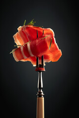 Sliced prosciutto with rosemary.