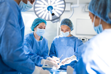 Doctor and assistant nurse operating for help patient from dangerous emergency case .Surgical instruments on the sterile table in the emergency operation room in the hospital.Health care and Medical - obrazy, fototapety, plakaty