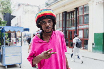 African American man with dreadlocks and a purple T-shirt in Latin America, rastafarian or rastaman...