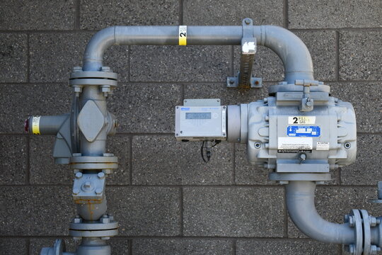 Dresser Natural Gas Solutions meter on side of public building.