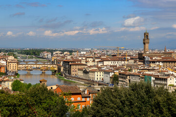 Fototapeta na wymiar View over the Arno river and the Palazzo Vecchio in Florence, Tuscany, Italy, on a sunny day in spring.