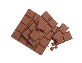 Pieces of delicious milk chocolate bars on white background, top view