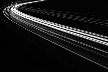 white lines of car lights on black background