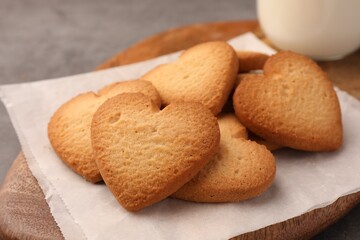 Heart shaped Danish butter cookies on wooden board, closeup