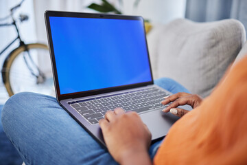 Woman, hands and laptop with mockup screen for communication, research or advertising at home. Hand of female person on computer display or chromakey for online browsing on living room sofa in house