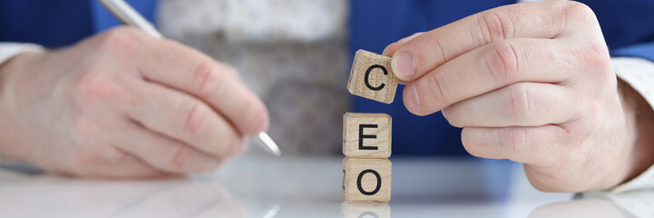 Businessman collecting words seo with wooden blocks