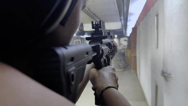 Woman Shooting with a Assault Rifle in Shooting Range in Switzerland.