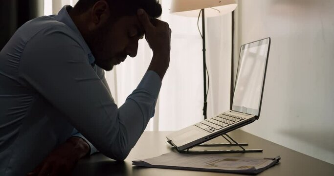 A businessman is suffering and feeling stressed about the assignment project not completed by deadline.