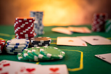 Fototapeta premium Chips are colored for poker and playing cards on the poker table before the game.