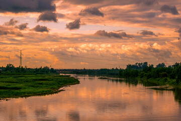 Fototapeta na wymiar Landscape of the river at sunset with a beautiful cloudy sky.