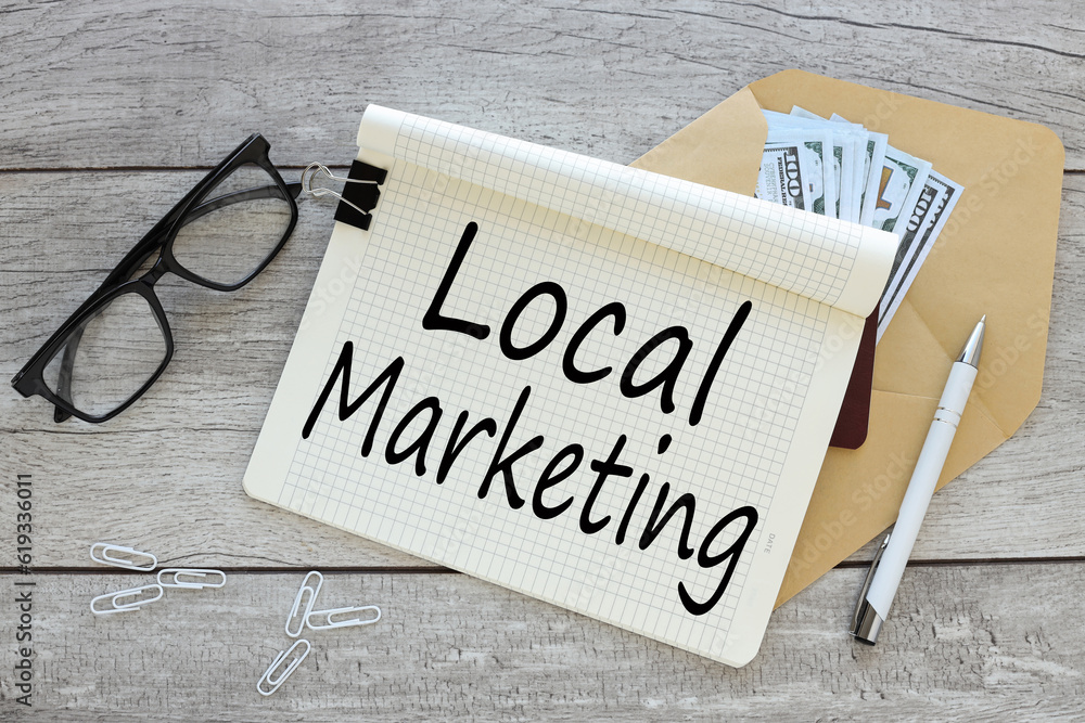 Poster local marketing business concept. open notepad with text on an envelope with money