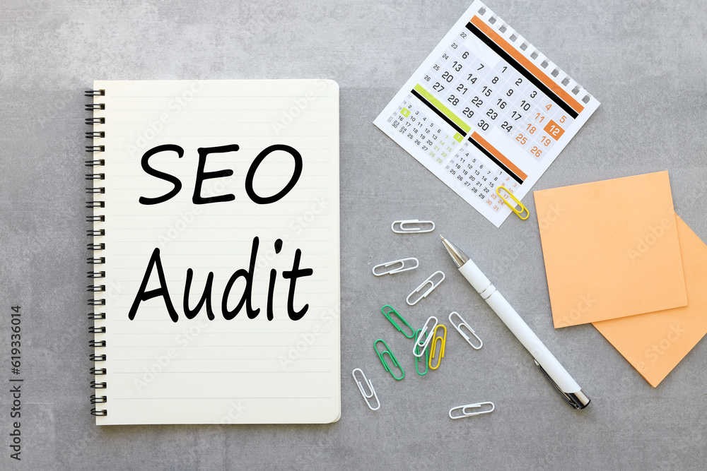 Poster gray background with notepad and calendar .text on paper seo audit. business concept.