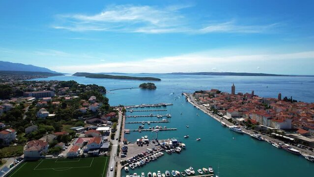 Rab - Croatia - An aerial view with the drone over the beautiful town of Rab - The drone rises above the town of Rab and the marina and opens up a fantastic view of the Croatian islands