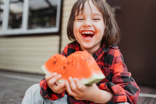 Cheerful Boy Holding Fresh Watermelon Slice