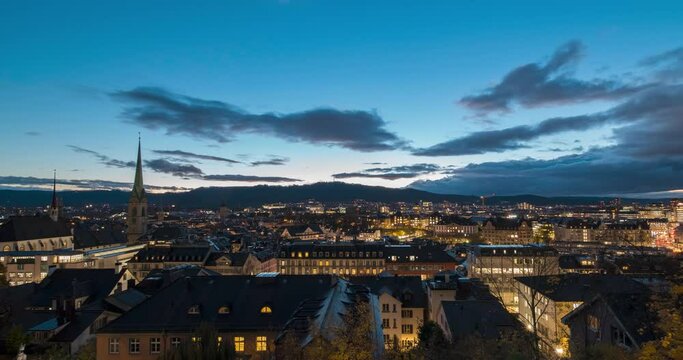 Historic city center of Zurich, the largest city in Switzerland. Beautiful blue hour cityscape panorama top view day to night timelapse. Downtown of swiss during dramatic sunset in time lapse.