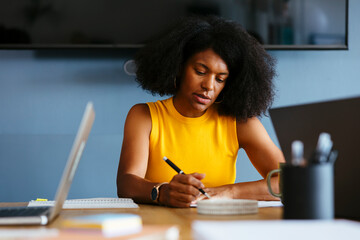 Businesswoman working at desk in creative office