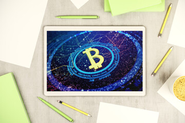 Modern digital tablet monitor with creative Bitcoin symbol. Cryptocurrency concept. Top view. 3D Rendering