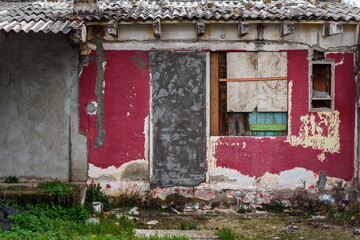 Old ruined house in slum with deteriorated facade