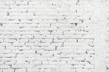 Old damaged brick wall painted in white color, vertical image