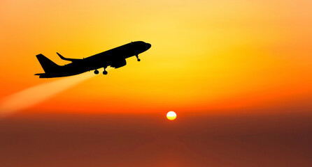 Passenger plane on the background of the sunset sky