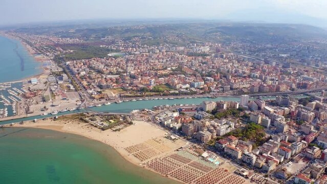 4k drone flight moving to the side footage (Ultra High Definition) of Pescara port. Beautiful morning seascape of Adriatic sea. Incredible outdoor scene of Italy, Europe.