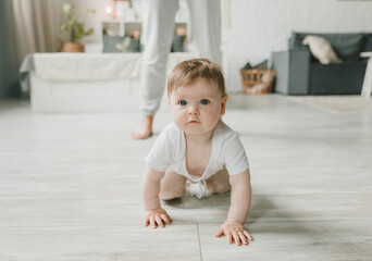crawling baby 6 months in the nursery at home.