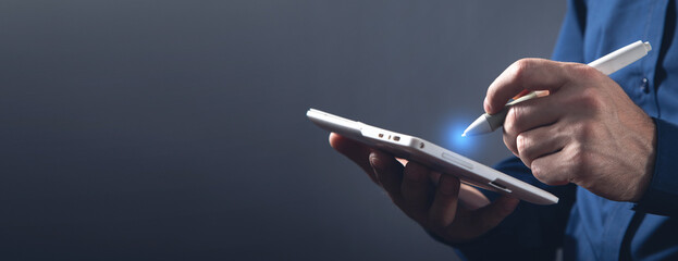 Graphic designer using tablet computer in office.