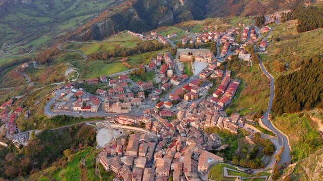 4k drone flight back footage (Ultra High Definition) of Stilo town. Stunning summer scene of Italy, Europe. Traveling concept background.