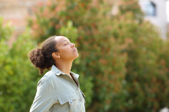 Black woman meditating breathing fresh air