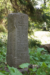 Historic tombstone, cemetery in the forest, abandoned. A historic burial site, a religious facility.