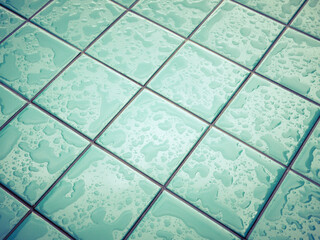 Shiny tile layer with drops of water. Wet aqua blue geometric background.