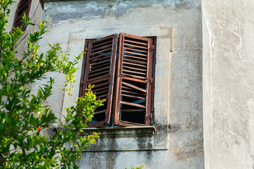 Broken windows shutters on and old building