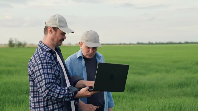 businessman farmer working field with laptop. partnership work. business partners talking about deal. agricultural industry farmer, digital computer, business transaction, conversation farmer field